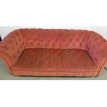 A button back Chesterfield sofa, upholstered in rose fabric, with gold braiding, with replacement