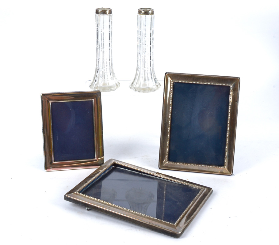 Three contemporary hallmarked silver photograph frames, the largest 24cm x 18.5cm, together with two