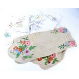 A collection of embroidered cotton and linen, including placemats, tablecloths, napkins and more,