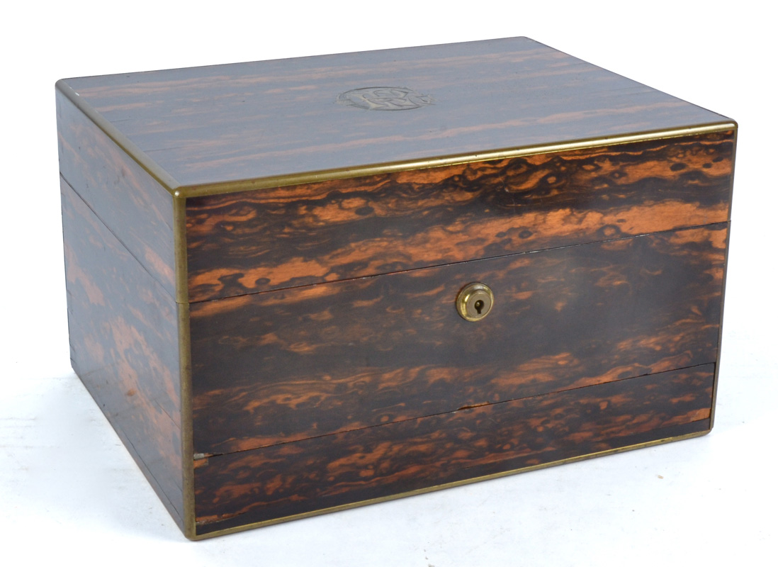 A 19th Century coromandel dressing table box with silver gilt fitted interior, with ten glass jars