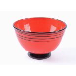 A glass bowl with applied black foot and upper black trailing on an intense red ground by Jens
