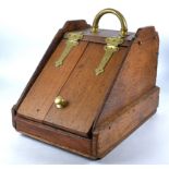 A large Oak coal scuttle, hinged to the top with brass fixtures and brass carry handle, with metal