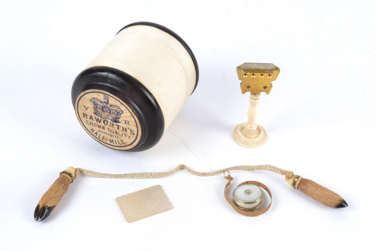A small selection of 19th Century sewing implements, including a mother of pearl tape measure