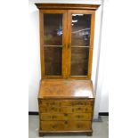 A Georgian figured walnut bureau bookcase, upper section with moulded cornice, two glass panelled