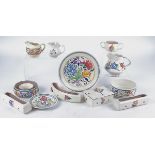 Eleven pieces of Poole Pottery dating to the mid 20th Century with stylised floral decoration, to