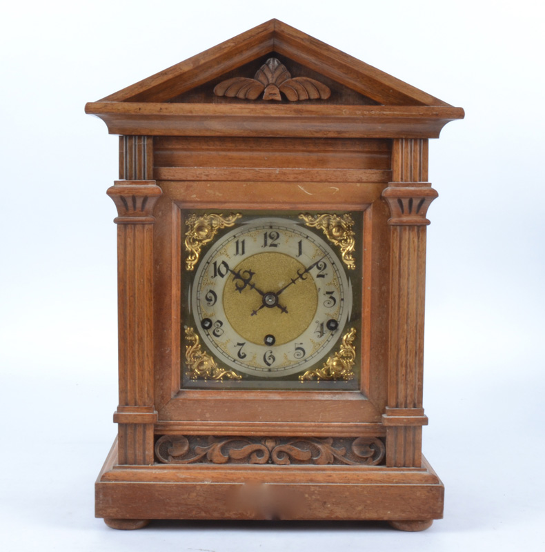 A early 20th Century German mantle clock, polished brass dial with Arabic numerals, movement by