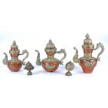 An Asian graduated three piece copper drinking set, each hot water pot with relief mounted