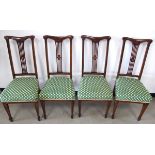 A set of four Edwardian inlaid stained beech dining chairs, shaped backs with pierced splat and