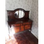 A 1920's mahogany mirror back cabinet, with two waist drawers above cupboards, on a cabriole