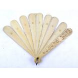 A 19th Century European ivory brisé fan, the sticks and guards with shaped ends, the guard carved