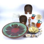 A collection of ceramics and pottery, including jelly moulds, a large circular dish glazed in red