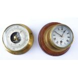 A 20th Century Smiths brass cased clock and barometer, the clock on wooden circular mount,