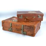 A tan leather travelling suitcase with 'Andes Cruise' and 'Elder Dempster Lines West Africa