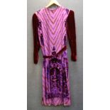 A lady's 1920's vintage dress, decorated with red and purple velvet motifs upon a purple sheer