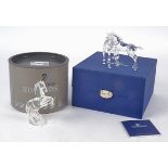 Two Swarovski Crystal models of horses, one of a pair interacting and being playful, the other of