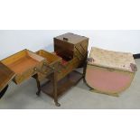 A mid 20th Century sewing box on wheels, the fold out top having multiple compartments, on raised