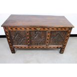 An antique oak panelled coffer, hinged plank top, the front having diamond shape carvings to