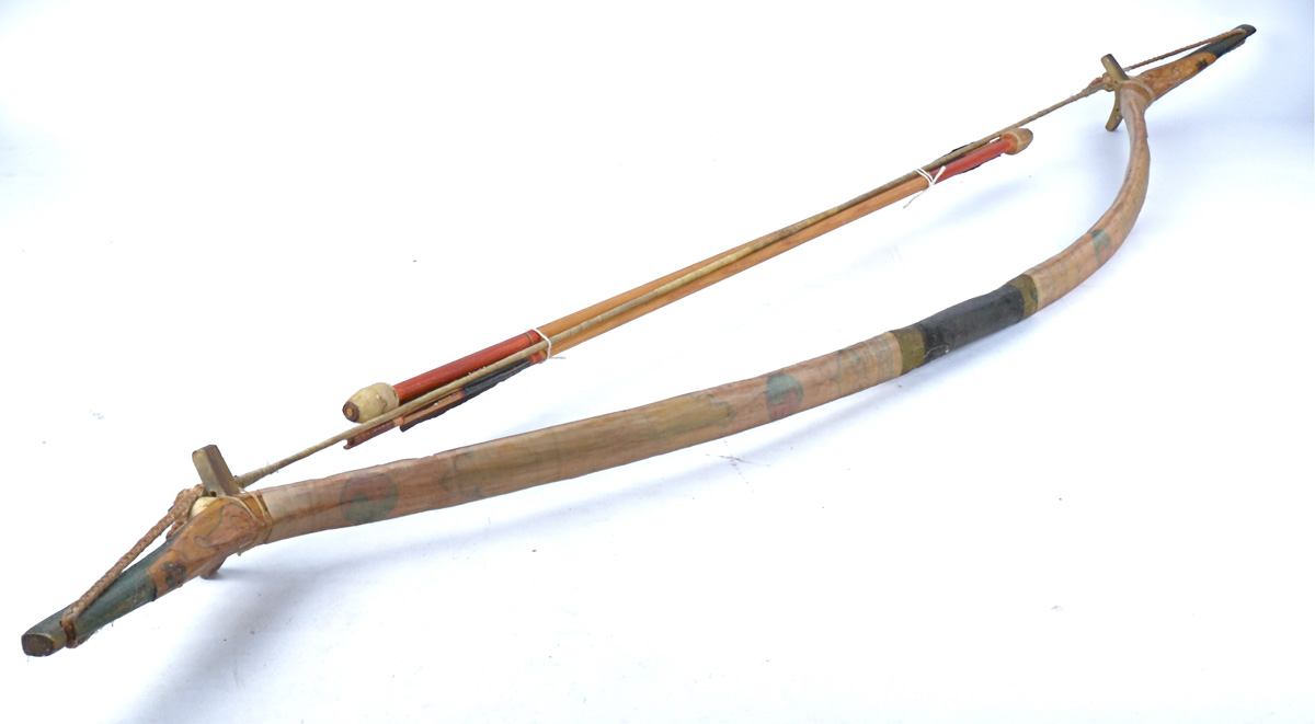 A Tribal bow and arrow, 150cm in length.