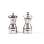 A hallmarked silver pepper mill and salt grinder, one Birmingham, the other London, probably John