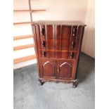 An American Chippendale style mahogany serpentine tall boy, with draws and cupboards on claw and