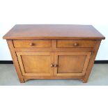 A contemporary hardwood sideboard, panelled side, two frieze drawers above a double cupboard,