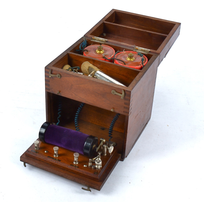 An early massage machine in a mahogany case, with three apparent settings, 19cm x 17cm x 17cm