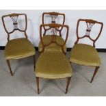 A set of four Edwardian walnut chairs, shaped backs with pierced back splats, raised on tapering
