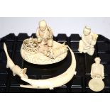 Two Meiji period Japanese ivory okimono figures, one a male figure crouching by a bundle of flower