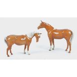 Two Beswick models of palomino horses, with printed marks to base, height 15cm & 19cm (2)