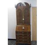 A continental style contemporary walnut bureau bookcase the top section having two panel doors