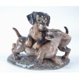 A Dahl Jensen Copenhagen porcelain dachshund group, no.1257, with printed factory mark to base,