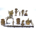 A collection of Benin brass objects, including two borough nut containers, two figures, a horse