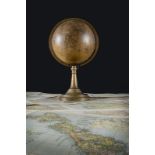 A Victorian terrestrial globe dating between 1840 and 1852, with brass bracket and stand,