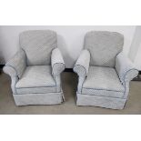 A pair of contemporary arm chairs, upholstered in a white and pale blue fabric sold together with an