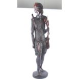 An African carved wooden figure of a warrior or hunter with a small antelope over his shoulder, with