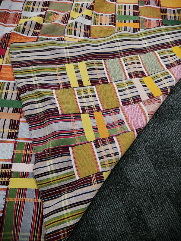 A Ewe woman's woven multi-coloured Kente cloth, 270cm x 180cm