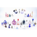 A collection of vintage and contemporary scent and perfume bottles, all empty, including blue