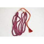 A contemporary Indian four strand ruby bead necklace, length of drop 23cm