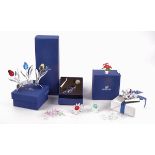 A collection of Swarovski Crystal flowers, including tulips, potted plants, lotus flowers and