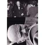 SIR WINSTON CHURCHILL Two black & white Press photographs: 9" X 8" smoking a cigar and 8" X 6" at