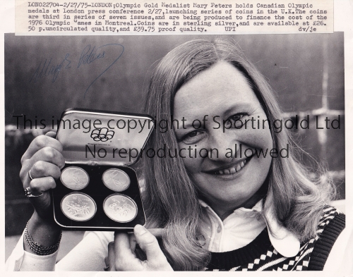 MARY PETERS AUTOGRAPH A 10" X 8" black & white signed Press photograph of Peters holding here medals