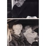 SIR WINSTON CHURCHILL Two black & white Press photographs: 9" X 7" smoking a cigar in a car with