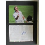 SHANE WARNE AUTOGRAPH A large 20" X 15" mount containing a colour photo of Warne celebrating