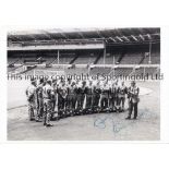 BOBBY MOORE AUTOGRAPH A 12" X 8" B/W photo of the England squad in tracksuits at Wembley stadium