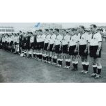 HORST ECKEL B/w 12 x 8 photo of the West German players lining up shoulder to shoulder prior to a