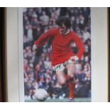 GEORGE BEST AUTOGRAPH A 29" X 24" framed and glazed signed colour picture of Best in action for