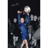 NOBBY STILES A col 12 x 8 photo of Stiles holding aloft the European Cup during celebration scenes