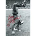 BRUCE GROBELAAR A b/w 12 x 8 photo of the Liverpool goalkeeper performing a hand stand during