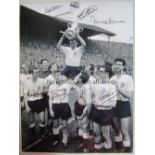 TOTTENHAM B/W 16 x 12 photo showing players gathering around captain Danny Blanchflower who holds