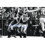 MANCHESTER UNITED B/w 12 x 8 photo showing Muhren and Macari celebrating with Frank Stapleton who